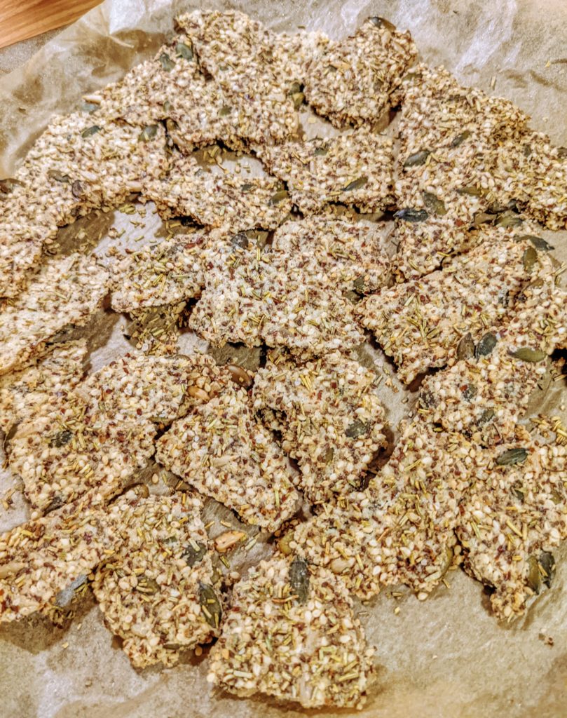 Rosemary and sea salt flaxseed crackers on baking tray